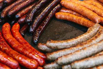 Many kinds of famous Bavarian fried sausages. National German food. Barbecue. BBQ. The outdoors and cooking on the fire.
