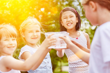 Gruppe Mädchen beim Wasser trinken im Sommer
