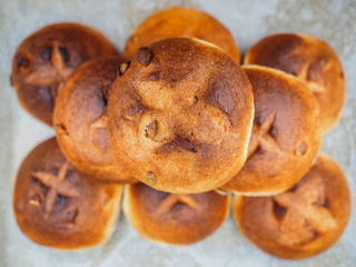 Pumpkin seed buns baked, in a pile on baking paper at close-up