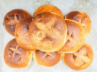 Fototapeta premium Pumpkin seed buns baked, in a pile on baking paper at close-up