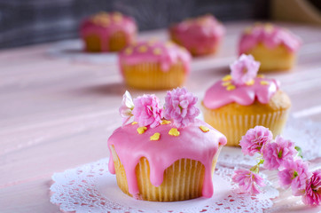 Cupcake with pink frosting and beautiful decoration closeup