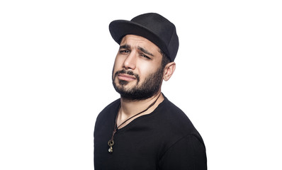 Portrait of young sad unhappy man with black t-shirt and cap looking at camera. studio shot, isolated on white background.