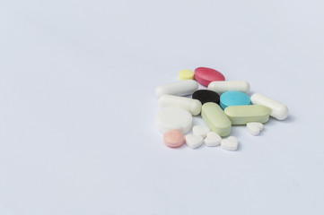tablets on a spoon close-up on a white background