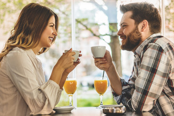 Happy couple enjoying a coffee at the coffee shop