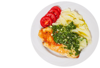 Roasted chicken breast with pesto sauce and mashed potatoes. top view. isolated on white
