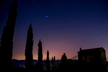Starry sky at dusk in the Tuscan countryside