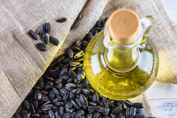 Sunflower seed and oils on wooden table.