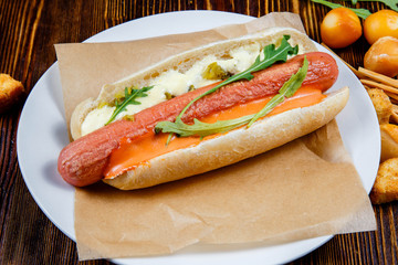 Hot dog with pickles and arugula and smoked beer snacks