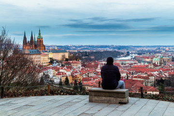 Unrecognizable tourist man enjoying great panoramic view oo the old town of Prague. Concept of Europe travel, sightseeing and tourism. Czech Republic.