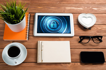 Web security and technology concept with tablet pc on wooden table