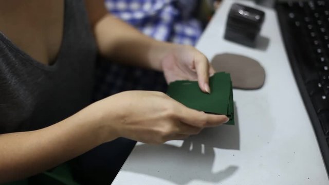 Young fashion designer woman working at home studio. Seamstress makes cutting work.