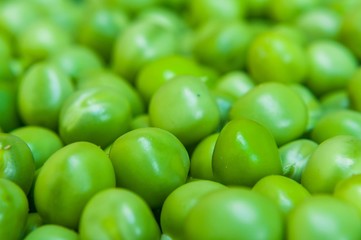 Background of fresh green peas. Selective focus. Macro shot