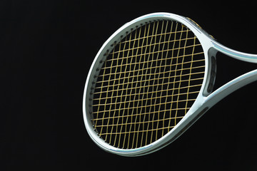 Tennis racket on black background