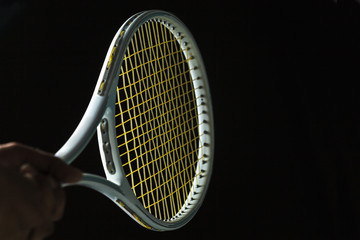 Tennis racket on black background