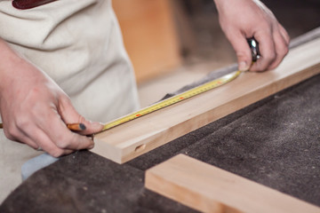 Fototapeta na wymiar carpenter painting a line for cutting wood