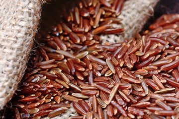 Red rice is poured out of the bag