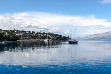 Fototapeta na wymiar Sailing boat in the beautiful blue lagoon. Yachting in Ionian Sea, Lefkada Island, Greece