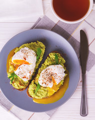Toast with poached egg, puree avocado, spices and arugula