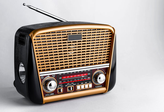 radio receiver in retro style with audio player and flashlight on white background