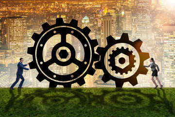 Businesspeople in teamwork example with cogwheels 