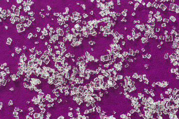 White sugar crystals on a bright raspberry background