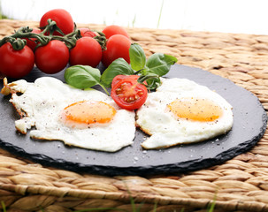 Fototapeta na wymiar fried eggs with basil pepper and salt