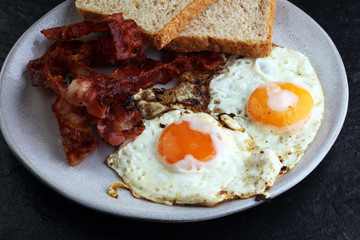 Ham and Egg. Bacon and Egg. Salted egg and sprinkled with black pepper. English breakfast.