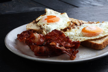 Ham and Egg. Bacon and Egg. Salted egg and sprinkled with black pepper. English breakfast.