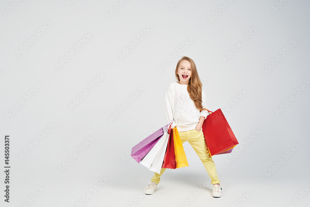 Wall mural girl with shoppers bags is posing