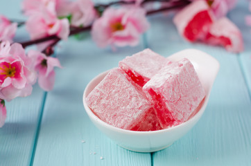 Rose flavored rahat lokum Turkish delight on wooden background. Selective focus. Ramadan food