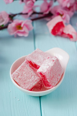 Rose flavored rahat lokum Turkish delight on wooden background. Selective focus. Ramadan food