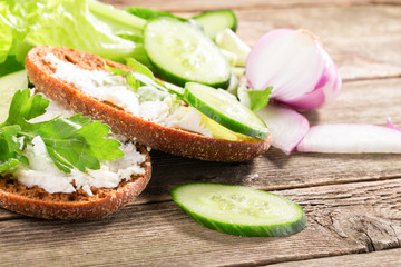 Rye bread with soft cheese and greens