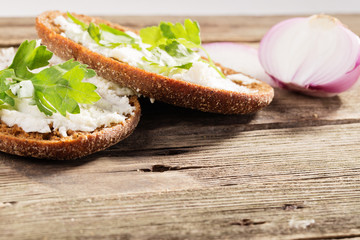 Rye bread with soft cheese and greens