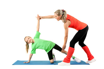 Trainer  teaches a little girl to perform an exercise on the mat on a white background