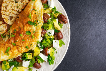 Mushroom, Feta Cheese egg Omelette witch Avocado, vegetables, lettuce, herbs and grilled bread.