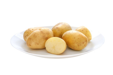 Raw potatoes on the plate isolated on white background