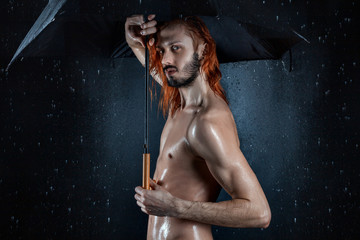Erotic wet man under the drops of water.