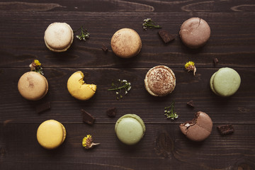 Sweet background. Delicious macaroons on the wooden table, top view