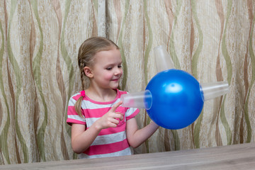 Fototapeta na wymiar girl spends physical experience with balloon and glasses