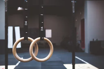 Poster Im Rahmen gymnastic rings in fitness gym © daniil