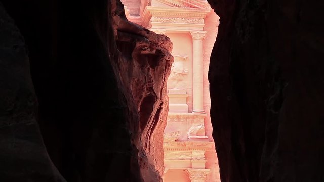Al Khazneh or Treasury - Nabatean rock-cut temple of Hellenistic period of ancient Petra, historical and archaeological city in Jordan. View from Siq - long narrow passage, gorge that leads to Petra