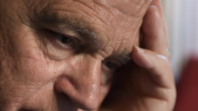 Pensive and sad man's eyes. Close up on old man's eyes