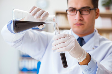 Chemical engineer working on oil samples in lab