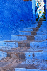 Blue wall and staircase in Chefchaouen medina, Morocco.