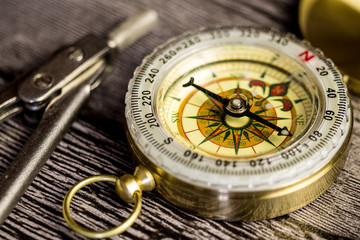 tourist compas and circinus on wooden table