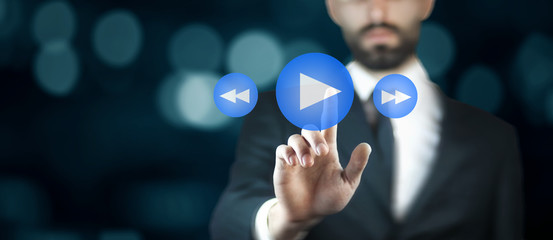businessman  hand press play button