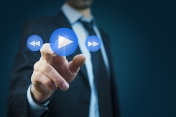 businessman  hand press play button