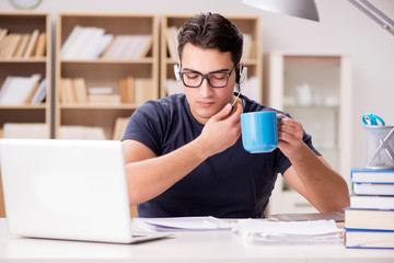 Young student drinking coffee from cup