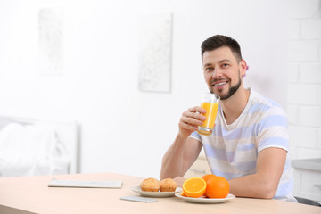 Fototapeta na wymiar Handsome man with juice at home