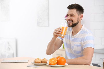 Handsome man with juice at home